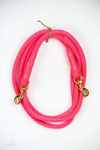 Pink MG reins, essential horse tack for communication and control while riding.